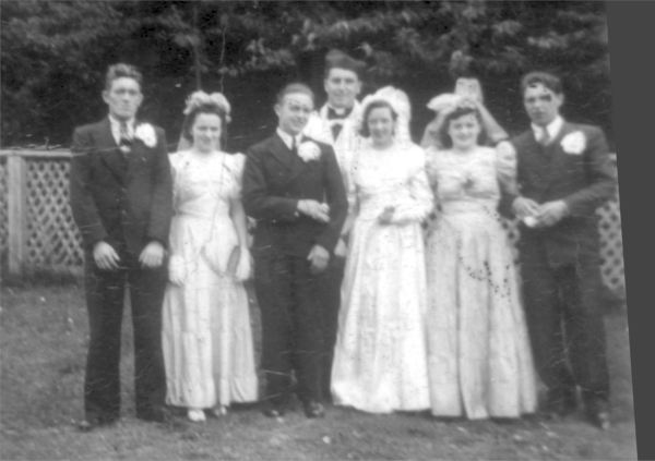 473: Della Norman's wedding. L-r Michael Norman, Elizabeth O'Leary, William O'Leary  (the groom), unidentified priest, Della Norman (the bride), Sarah Norman, and  James O'Leary. (1943) [courtesy of Della (Norman) O'Leary]  - Della, Michael and Sarah children of Thomas Norman &amp;amp; Jane Traverse;  Elizabeth and James O'Leary siblings of the groom